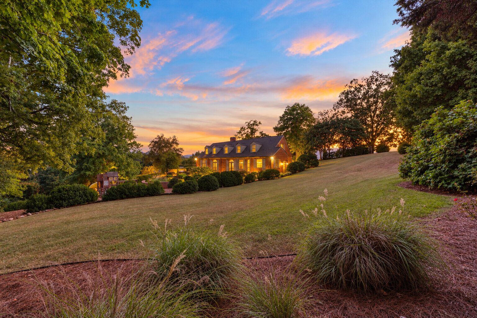 Oak Cliff Manor glowing at dusk