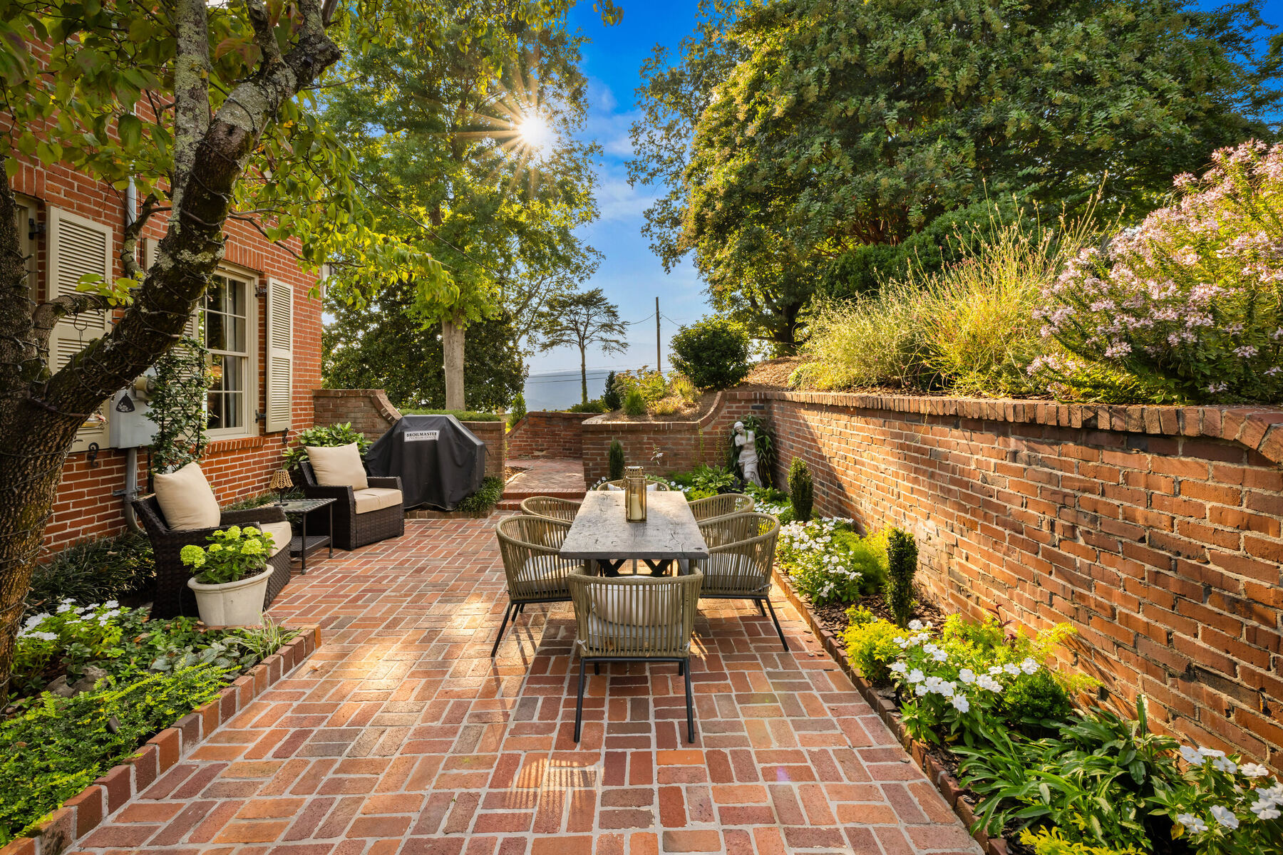 Brick garden terrace beneath a mature tree