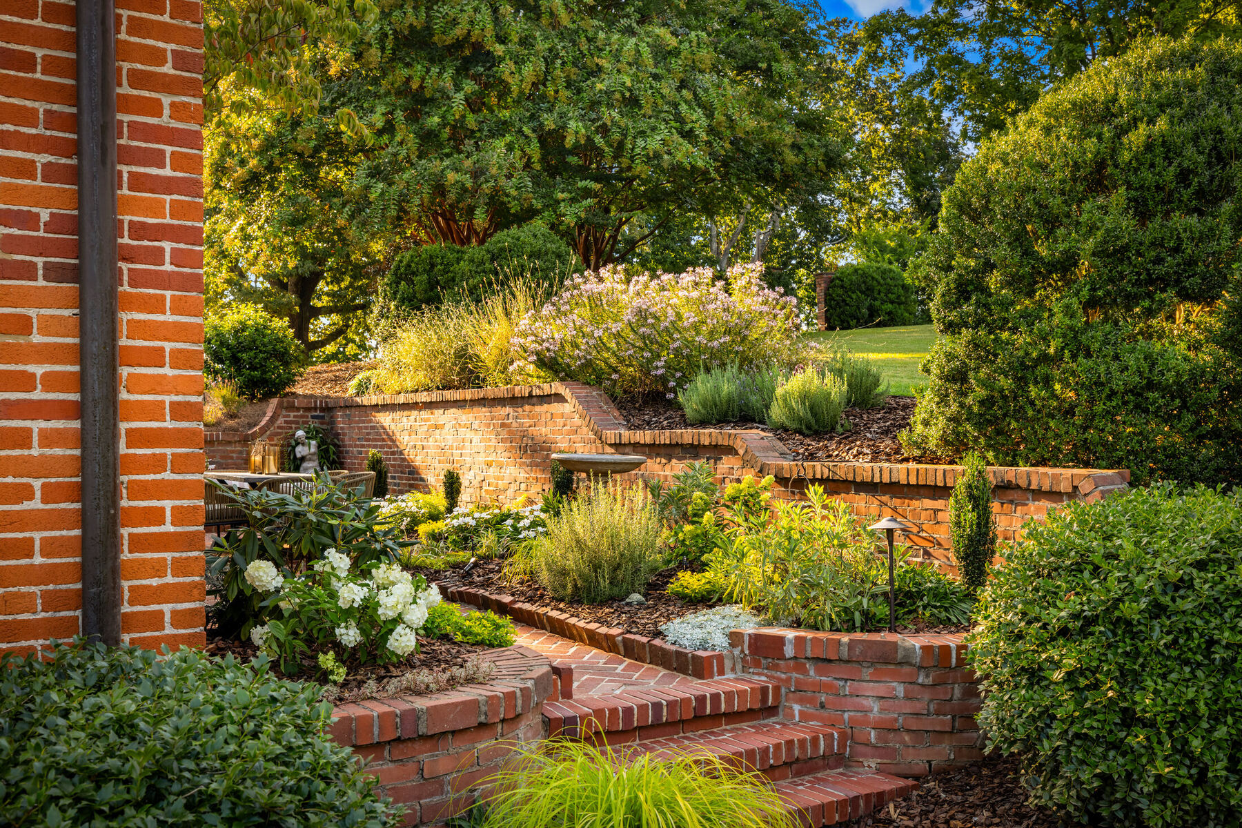 Terraced brick garden planted with hydrangeas