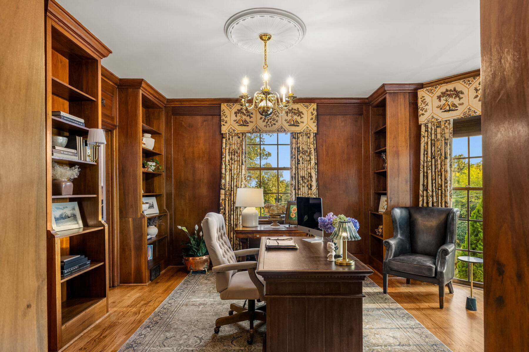 Wood-paneled library with built-in bookshelves