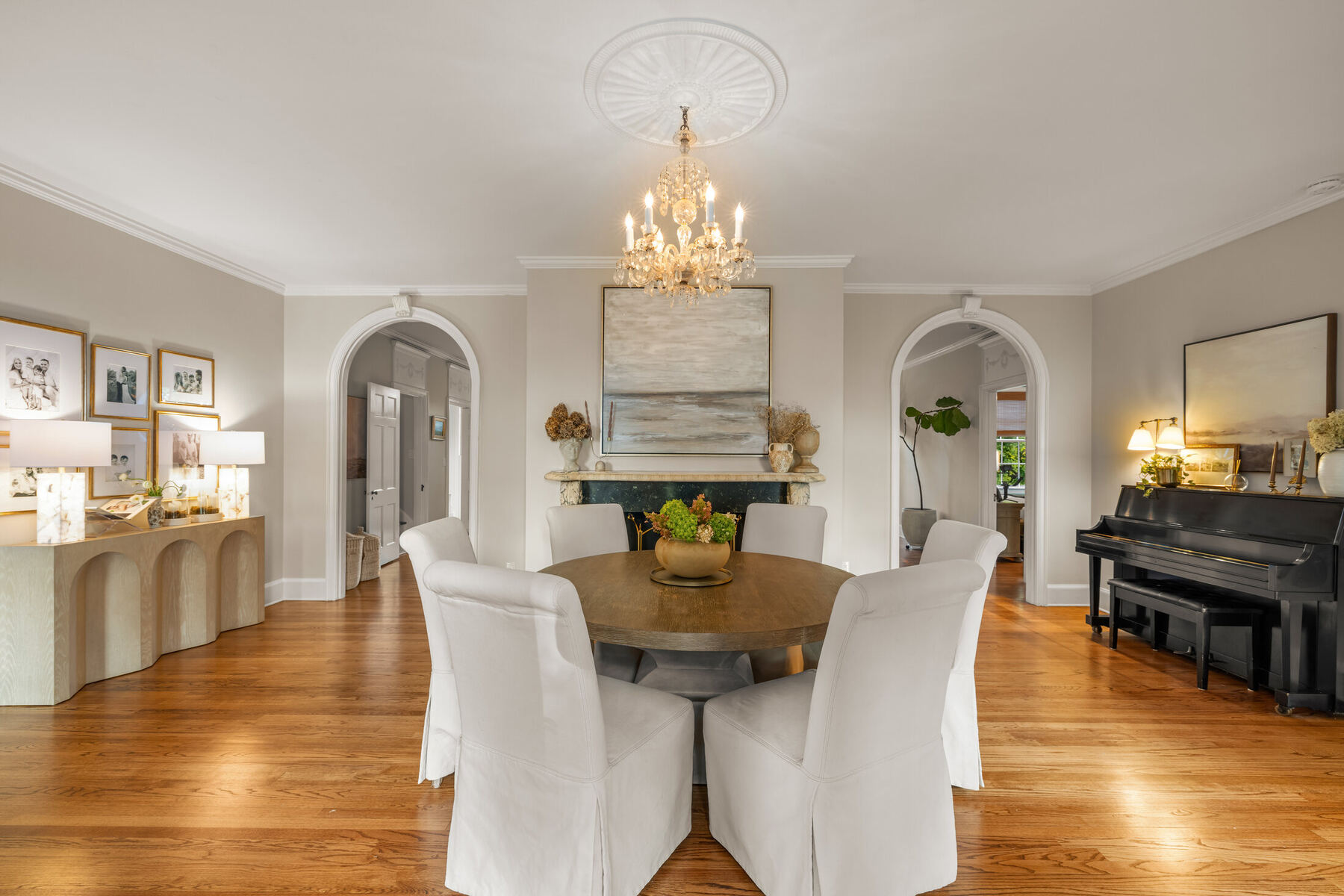 Dining room with marble fireplace and arched openings